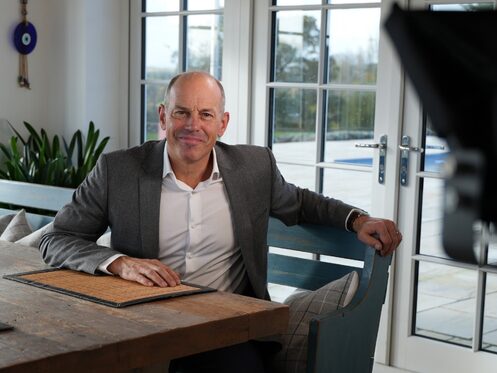 Phil Spencer sitting on a bench and smiling at the camera