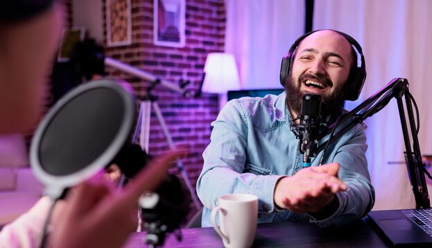 A man with headphones recording a video podcast.