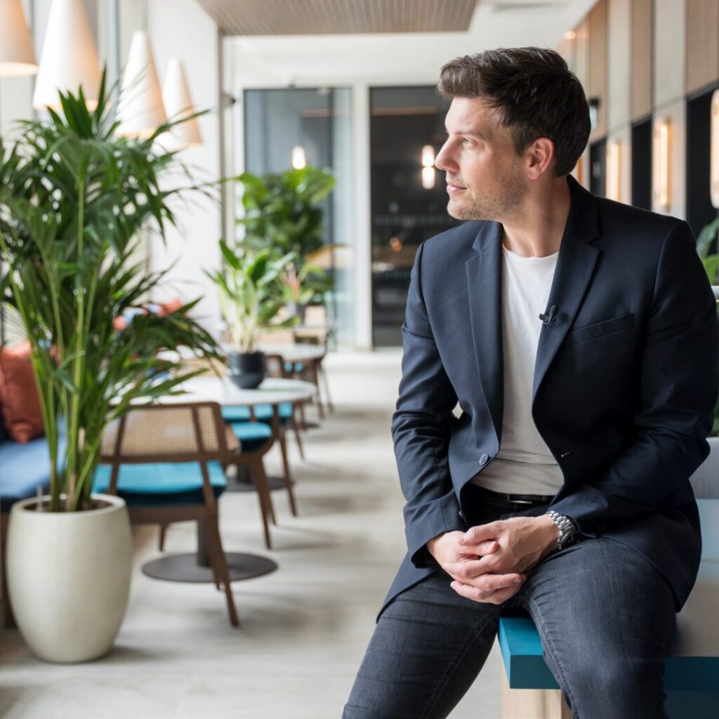 A man looking to his right in an office cafeteria.
